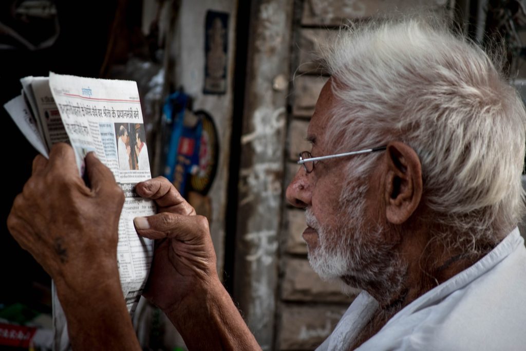 Old man reading the newspaper