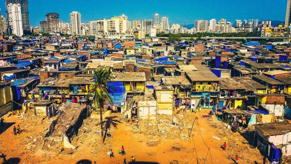 Slum  in Mumbai, inhabited by India's poor people. In the background can be seen high-rise buildings, where only the rich can afford to live